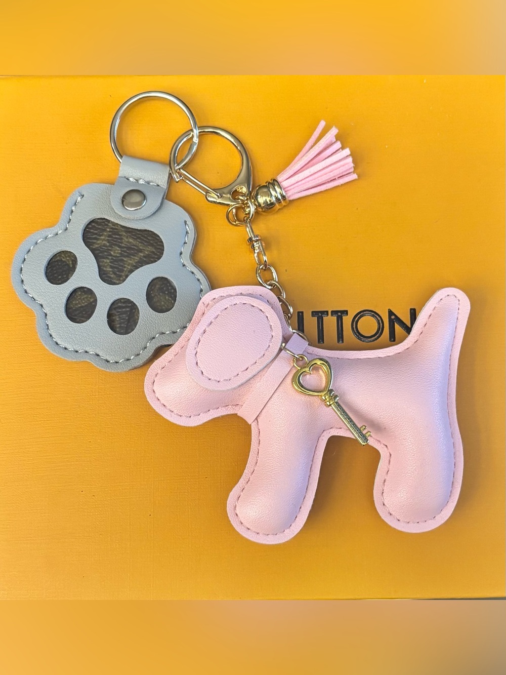 Authentic Louis Vuitton
Material Bag Charm, Dog, Paw, and LV key charm.